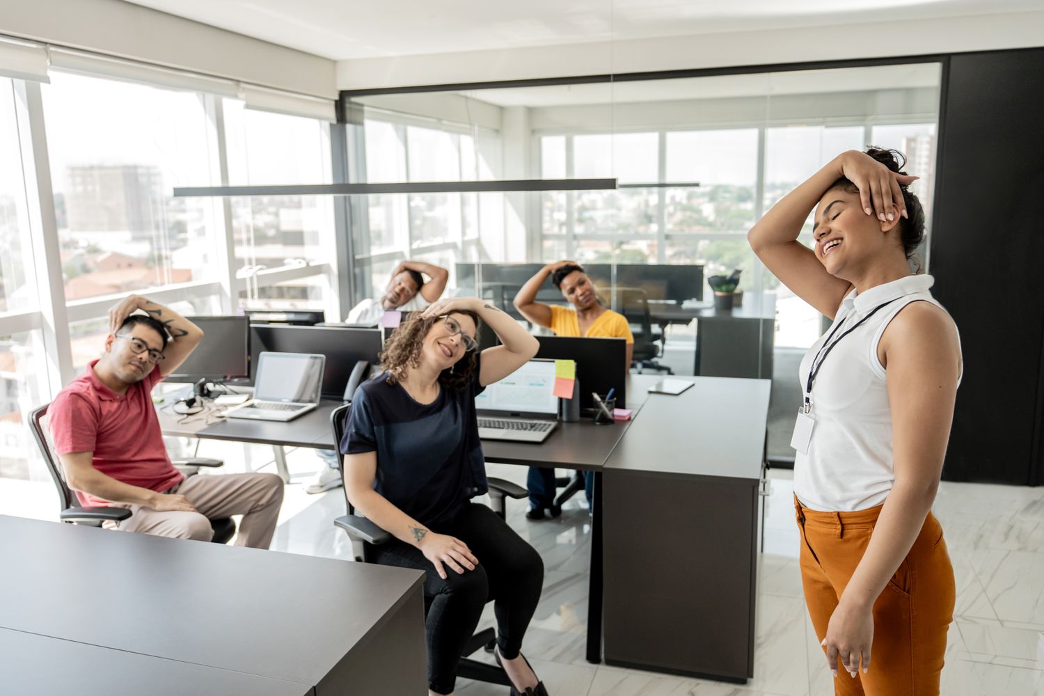 Professional office environment with employees participating in workplace wellness activities